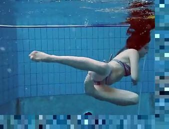 Underwater with a bikini girl stripping in the pool