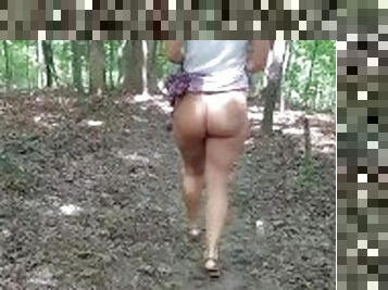 Big booty milf walking through the woods with her skirt up
