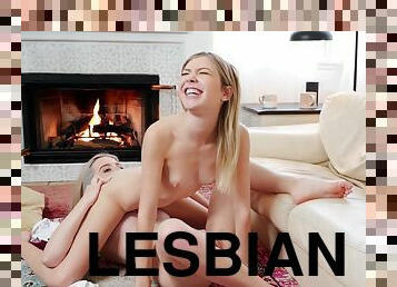 Pair of blonde-haired cuties make love by the fireplace