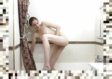 Solo brunette girl masturbating in the bathroom under the shower in 4K.