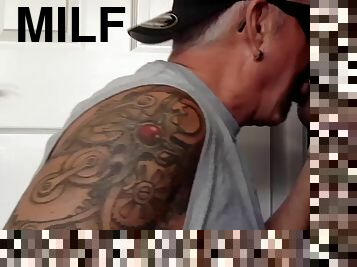 Tattooed milf at the glory hole sucks cock until cum in greedy mouth