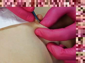 A male beautician tears off the hair on the nipples of a girl during depilation