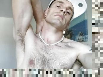 Showing off armpits, hairy chest, flexing