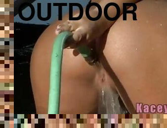 Wet teen babe posing outdoors