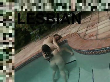 Tanned lesbians are playing in the pool