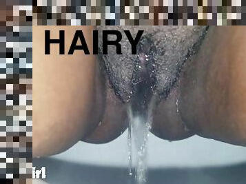 Hairy black pussy pissing