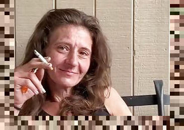 Everyone's favorite Aunt caught smoking and playing with her pussy on the porch.