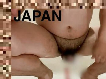 Japanese hairy cock sucks on a real dildo and inserts it in the anus