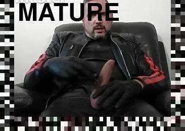 Leather daddy jerks his uncut cock and plays with foreskin before cumming on leather gloves PREVIEW