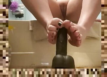 stroking big dildo with feet