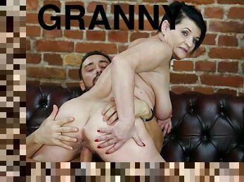 Short-haired granny with a huge sexual appetite shagged on leather couch