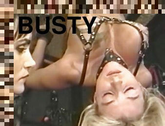 Busty blonde bottom tied up for spanking in bdsm dungeon