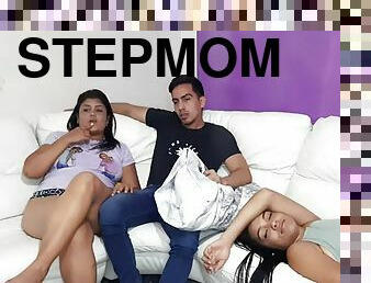 My stepmom sucks my cock without my stepsister noticing while we watch a movie