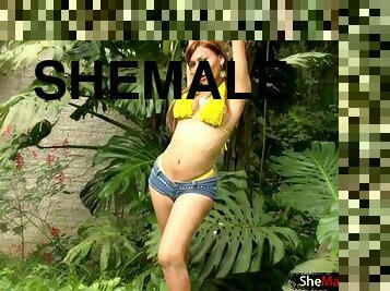Shemale female is yellow bikini over and masturbating