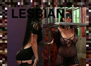 Caged woman plays submissive in lesbian BDSM