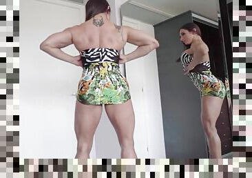 Karyn bayres flexes her muscular body in front of a mirror