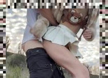 Cute petite blonde girl gets fucked outdoors by the lake in a teddy bear outfit