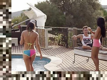 Two horny sluts fuck with a hunk by the pool