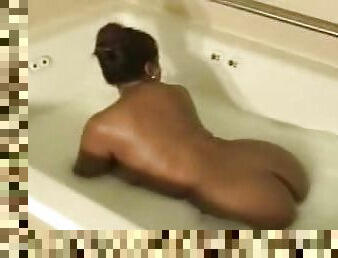 Black BBW soapy in the bathtub