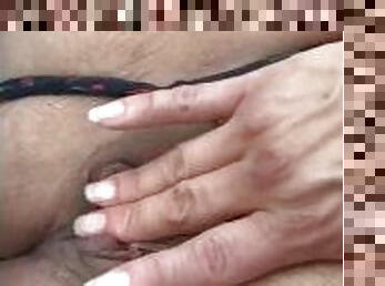 Mature Latina fucking her fingers in public.