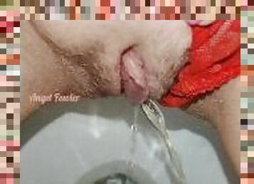Delicious piss with red panties pushed aside in the toilet