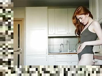 Redhead with small tits masturbates in the kitchen