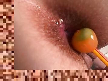 Orange lollipop ???? is playing with my anal and tearing to get inside