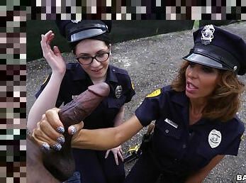 Sexy female cops share black meat on the street