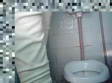 Hidden cam is filming sweet brunette pissing in the toilet