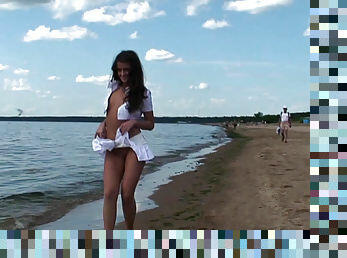 Beautiful flashing girl at the beach