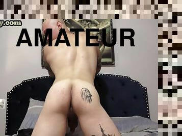 Lone military stud with tattoos jerks his cock in the bedroom