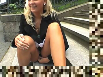 Upskirt flashing blonde is happy to suck a cock in public
