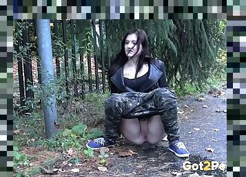 Camo pants on a babe pissing on the sidewalk