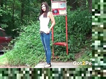Chick in tight jeans takes a piss in public